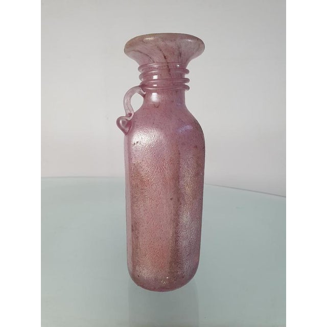 An iridescent pink vase in pink / mauve colored Murano glass attributed to famous glass artist Archimede Seguso Archimede...