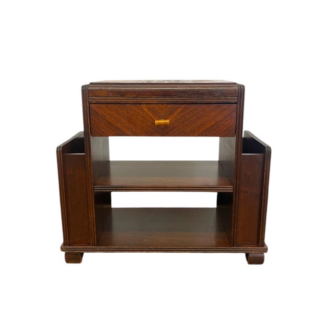 This vintage Art Deco end table features a distinctive design with dual integrated magazine racks on each side, combining...