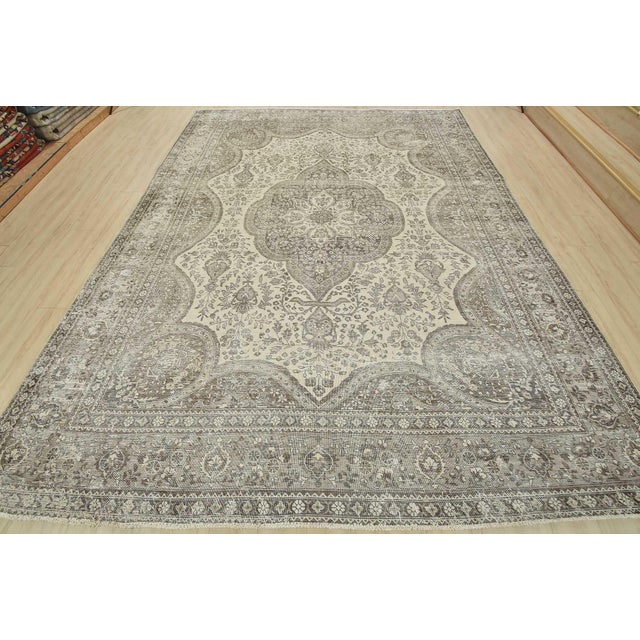 An authentic vintage traditional Tabriz rug hand-knotted with fine wool and natural dyes. This oriental rug features muted...