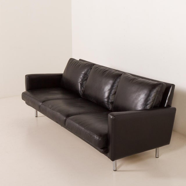 This mid-century black leather sofa was most likely made by herman miller and designed by george nelson. It seems...