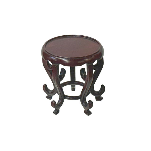 Elevate your cherished treasures with this stunning, small reddish-brown round display stand, a perfect blend of...