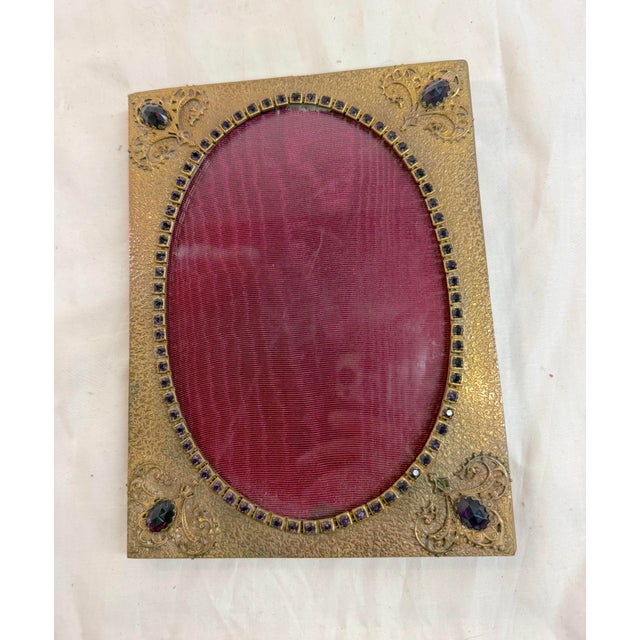 Up for sale is an antique ornate purple jeweled bronze picture frame with an oval opening and rectangular shape. This...