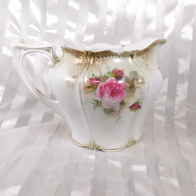 This is a rather large water jug or pitcher by Reinhold Schlegelmilch RS Prussia. I do not know the pattern name, but it...