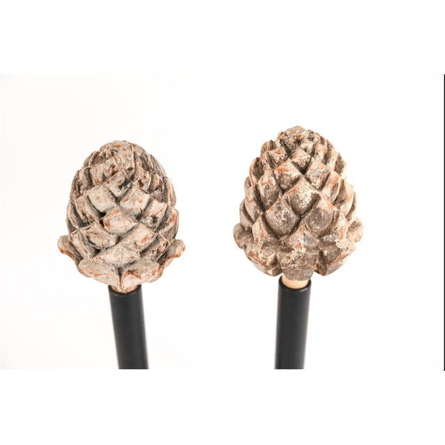 A pair of antique carved wooden architectural-salvaged artichoke finials in a distressed whitewash finish with...