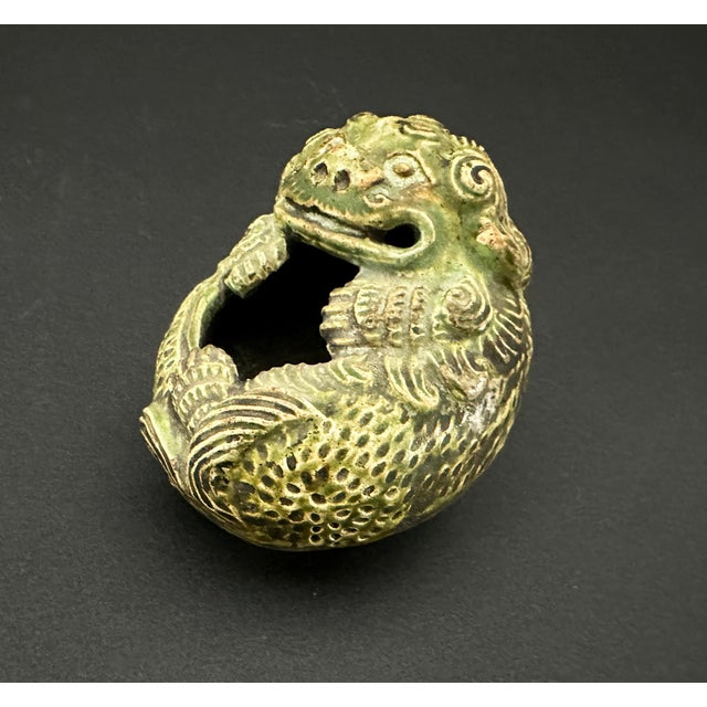 A small vessel used for washing calligraphy brushes. This water coupe is in the form of a Foo Dog, also known as guardian...