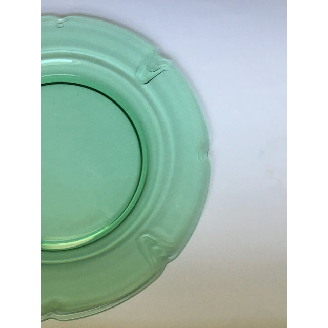 A beautiful transparent glass platter divided into four sections by a trio of simple curves with a dimple in the center of...