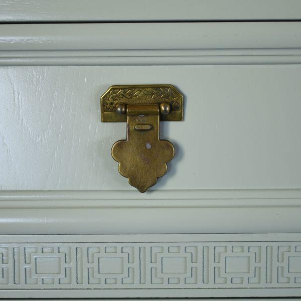 A Shangri La tall boy chest, its tall, narrow case stacked with drawers for efficient, elegant storage. The chinoiserie-...