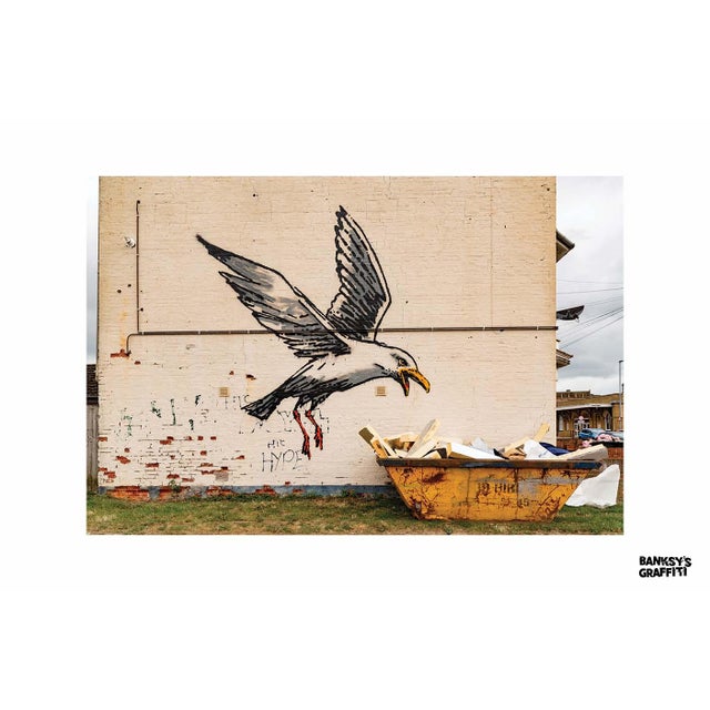 Seagull Raiding A Dumpster is one of Banksy's most iconic graffiti artworks, showcasing his signature style of social...
