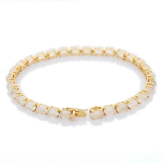 This is part of Chairish’s Fine Jewelry assortment. This Rainbow Moonstone Gemstone Tennis Bracelet in 14K gold showcases...