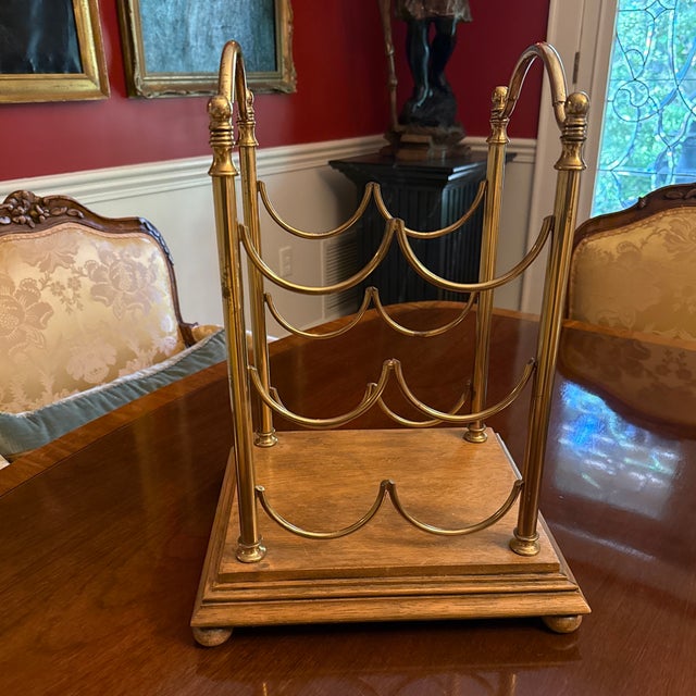 A beautiful and classic French or Italian brass and mahogany wine bottle stand for six bottles of wine. The brass rack...