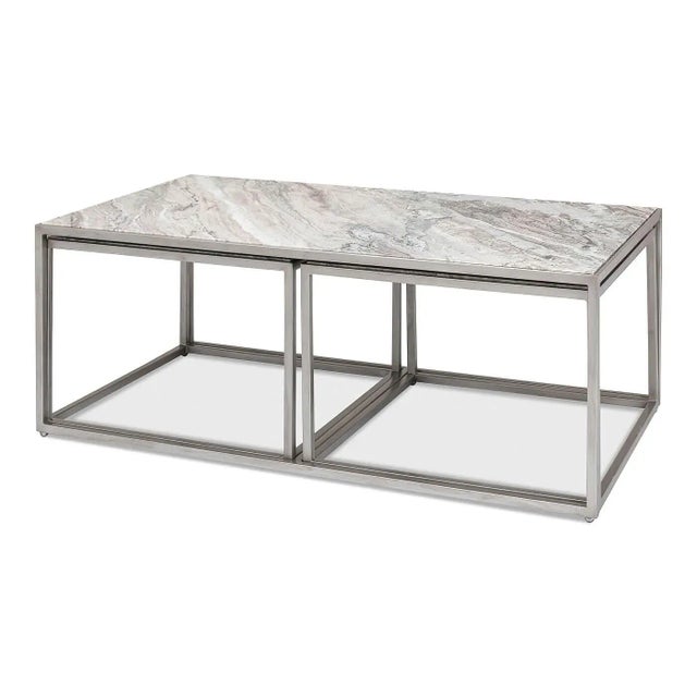 Modern marble 3 piece coffee table set. An elegant marble top sits on a metal base in an antique silver finish. The...