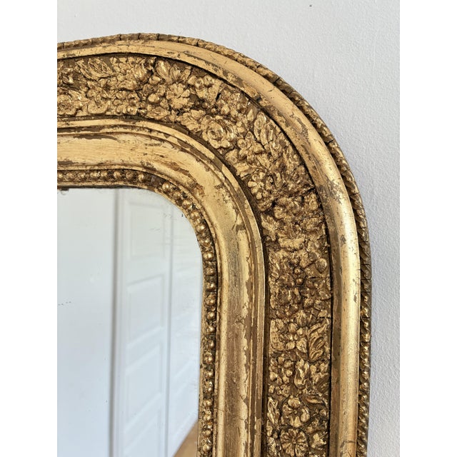 An antique French Louis Philippe mirror, dating to the late 19th century. This mirror has a giltwood carved frame with a...