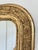An antique French Louis Philippe mirror, dating to the late 19th century. This mirror has a giltwood carved frame with a...