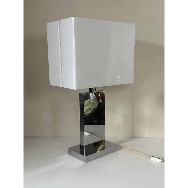 Rare and large chrome table lamp designed by Florence Casey in the 1970s. The body is chromed metal and the shade is white...