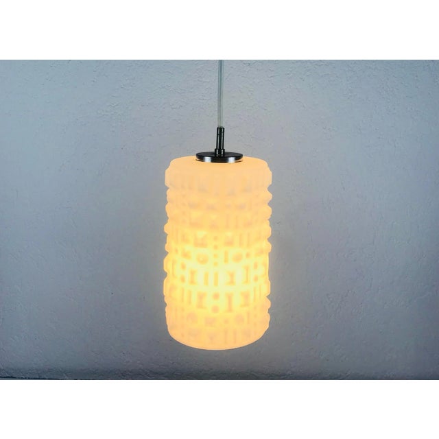 A Peill and Putzler hanging lamp made in Germany in the 1970s. It is fascinating with its glass ornaments. Textured...