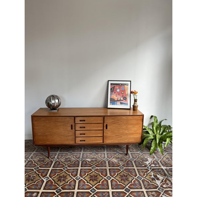 Elegant sideboard by meredew with refined handles integrated into the cabinet. manufacturer: meredew, uk period: 1960s...