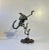 Piece Unique: A wellmade scrap-metal figurine depicting an Alien. Bolts, a spring, a chain-saw spark plug, steel bits and...
