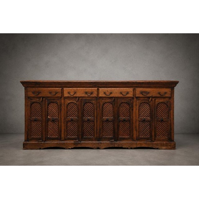 A magnificent antique Indian sideboard handcrafted from solid wood, featuring eight beautifully carved lattice-panel...