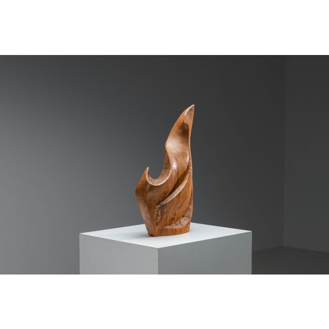 A striking and highly distinctive vintage sculpture carved from solid walnut, featuring a powerful, organic form and a...