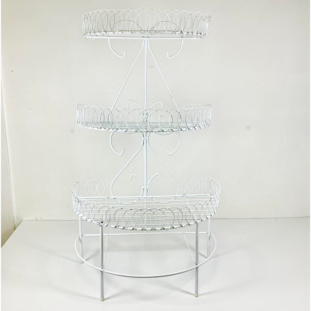 This is a delightful 3-Tiered wire metal plant stand. It has a wonderful loop design that forms the edges to three half-...