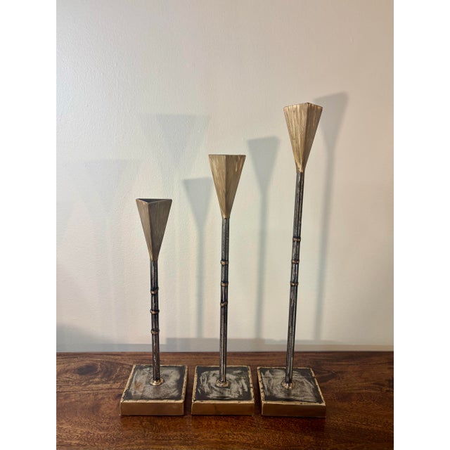 A striking set of hand fabricated American studio Brutalist candlesticks, individually signed and dated 2002. Constructed...