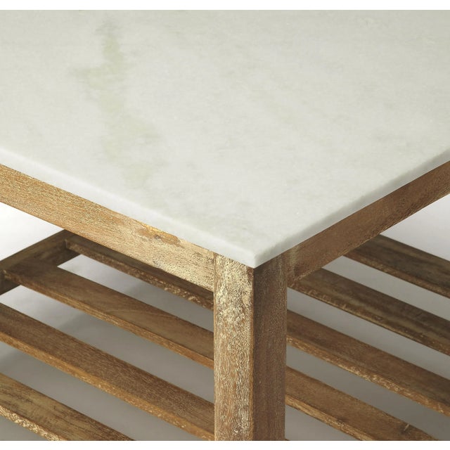 This attractive coffee table is a stunning addition in any rustic modern living room or office. Its slatted base crafted...