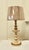 Folk Art Style carved and painted table lamp. This lamp has a carved decoration painted in cream with gold highlights, the...
