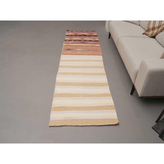 Vintage Hand-Knotted runner rug is a semi-antique vintage runner rug. The '70s Eastern region of Anatolia's unique rug is...