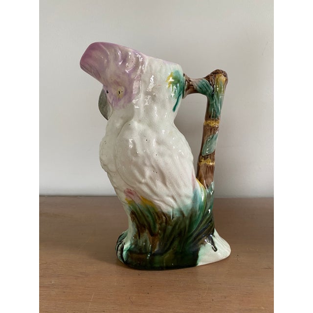 A wonderful 19th century ceramic majolica pitcher in the form of a cockatoo. The bold colored glazing on this pitcher is...