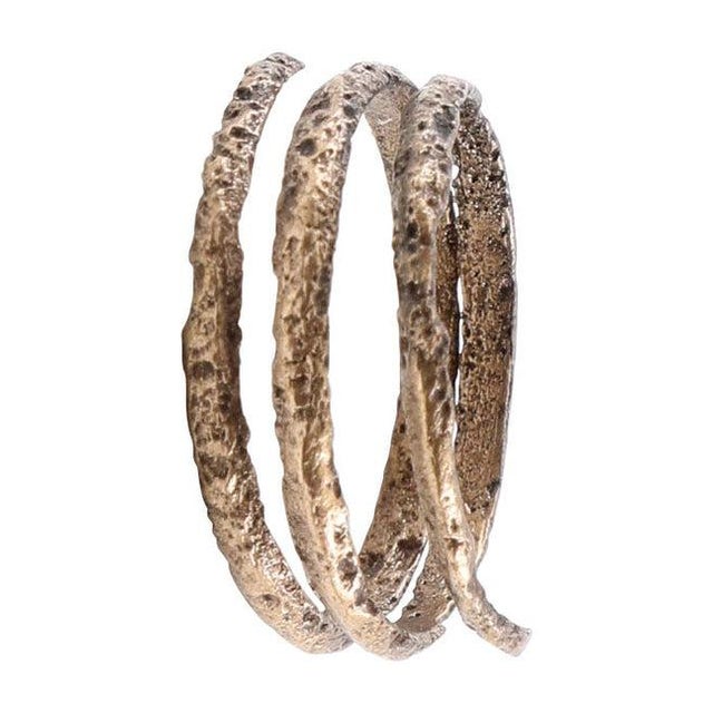 Gilt bronze, size 7 3/4. Rounded front, flat back section band in 2 1/2 full coils. Measuring 4.0mm at the narrowest to...