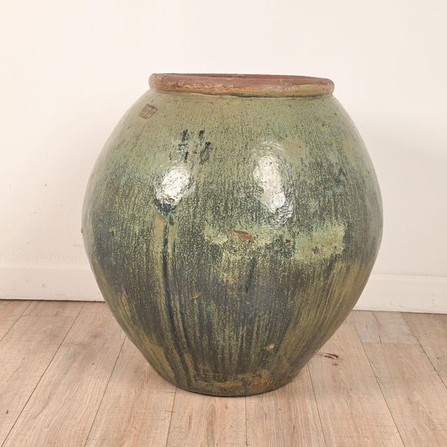 A massive celadon glazed Chinese pot.
