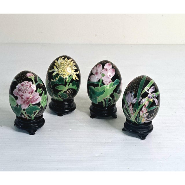 A beautiful vintage set of four Chinese cloisonné enamel porcelain eggs, each decorated with intricate gold‑outlined...