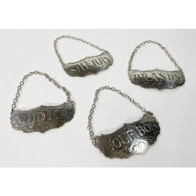 Set of four vintage Stieff Historic Newport pewter liquor decanter label tags in original box. Set includes one each of...