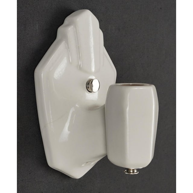 Art Deco style white porcelain wall sconce. This sconce requires one Edison style medium base bulb. Good condition with...