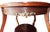 Intricate inlay, cast brass accents, and gilt painted accents combine to make this table from the early 20th century a...
