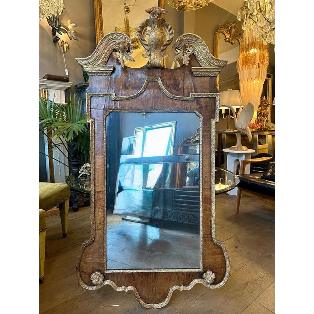 A mid 18th century Georgian Pier mirror of giltwood and walnut. The carved broken pediment top in giltwood with decorative...