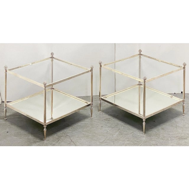 A pair of elegant French two-tiered low side or end tables in the Mid-Century Modern style - each table featuring one...
