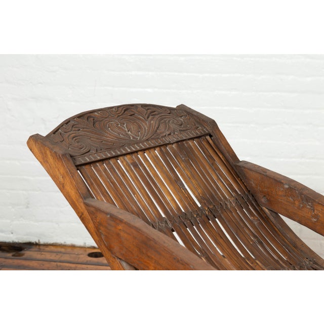Antique Indonesian Reclining Plantation Chair with Bamboo Slats and Carved Décor For Sale - Image 4 of 10
