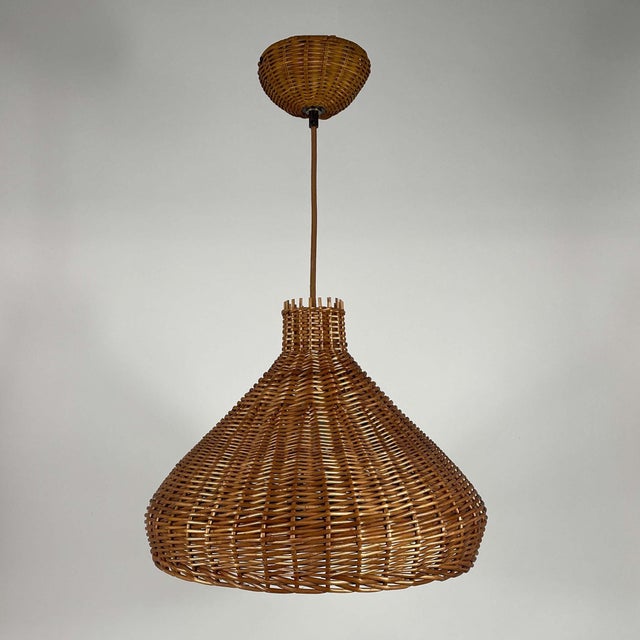 This rattan pendant or suspension light was designed and manufactured in sweden in the 1960s. It features a large tulip...