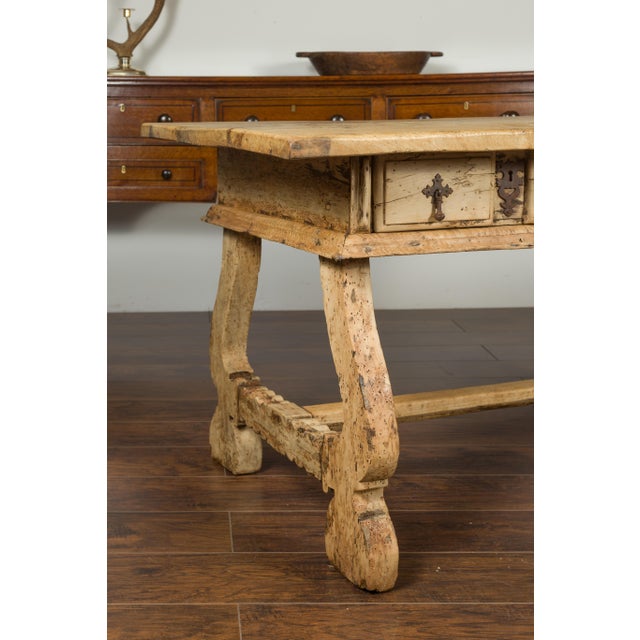 A Spanish Baroque style freshly bleached walnut trestle base farm table from the early 19th century, with two drawers and...
