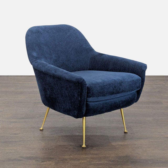 Relax in comfort and style with this West Elm lounge chair. Features soft ink blue upholstery and sturdy gold metal legs....