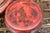 A pair of antique Chinese red lacquered covered boxes. The larger box has a domed lid painted with a traditional Chinese...