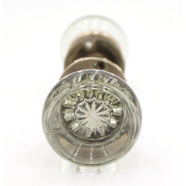 Art Deco style glass passage door knob set with clear glass knobs and brushed nickel rosettes. The original mounting...