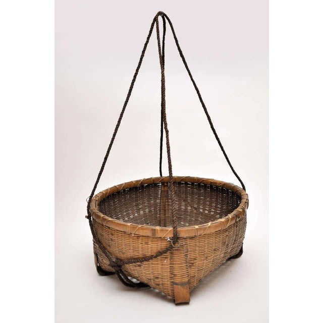 20th century Japanese fishing basket. Beautifully woven with long rope handles. Handles extend approximately 2 feet past...