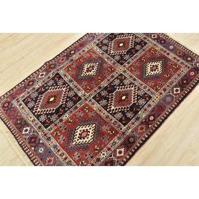 An authentic vintage tribal Yalameh rug hand-knotted with fine wool and natural dyes. This finely woven nomadic rug...