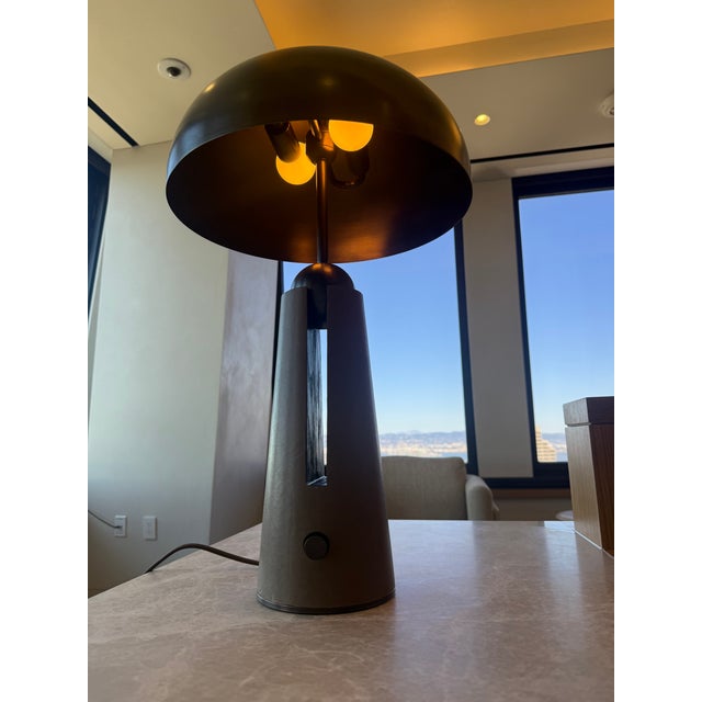 This is a designer table lamp by Apparatus within the metronome line. It is in the oiled rubbed bronze and suede. This is...
