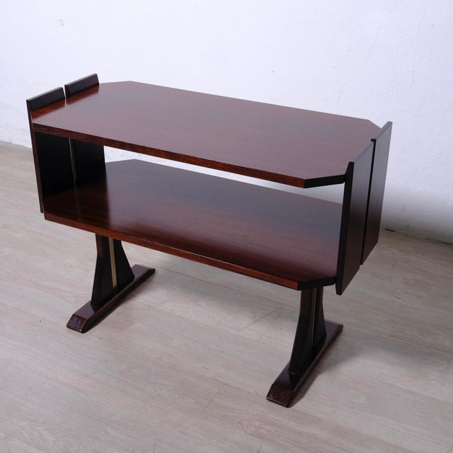 A beautiful bedside table, a small wooden table with metal detailing on the legs. 1960s design. Dimensions: Width: 84 cm...