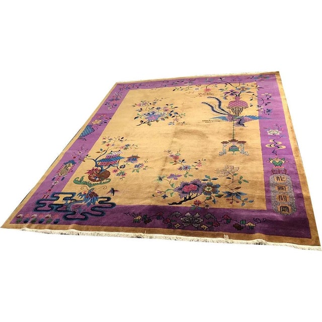 Add a touch of luxury and elegance to your space with this stunning antique Chinese rug. Measuring 9'x12', this...