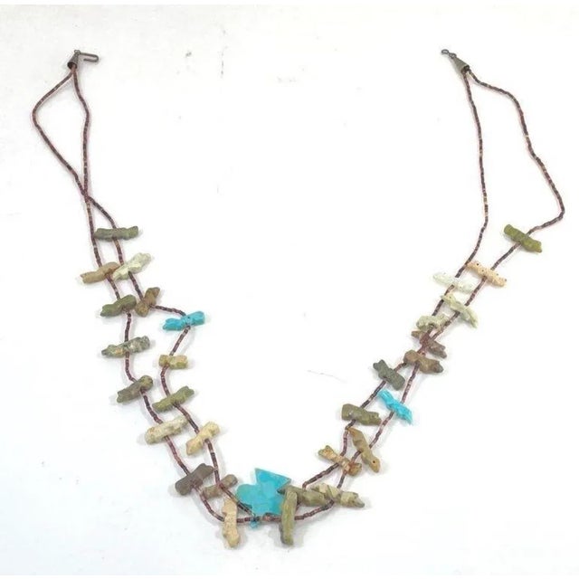 This fetish necklace originates from the Pueblo Native American tribes, likely Santo Domingo (Kewa Pueblo) or Zuni, and...