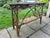 Handcrafted rustic twig console table featuring a slatted top, decorative bentwood arches, lattice sides, and a lower...